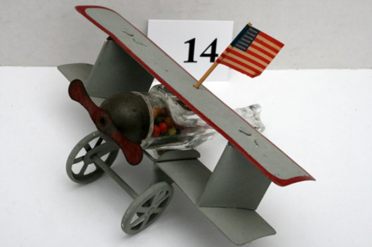 Though the wings, landing gear and flag have been replaced, this Liberty airplane with original candy is a desirable container. Image courtesy Old Barn Auction.